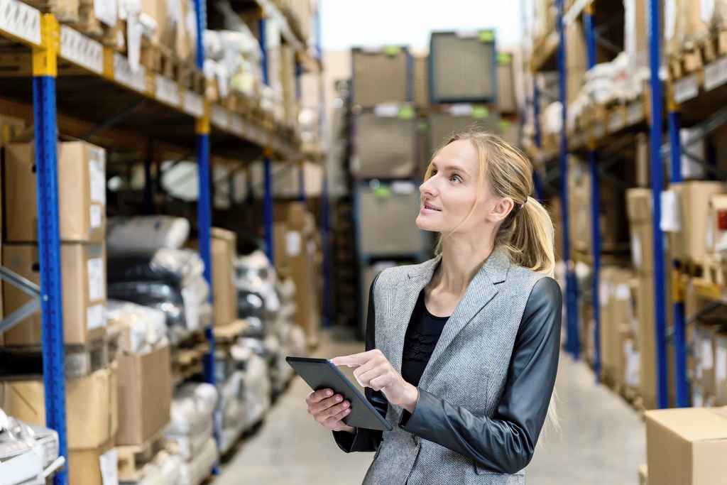 Woman using Amazon inventory management software in warehouse