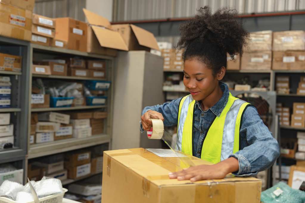Warehouse worker packing ecommerce orders